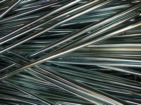 Many Metal Rods Are Stacked Together On The Ground