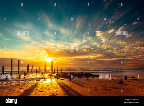 Port Willunga Beach View With Jetty Pylons In The Water At Sunset