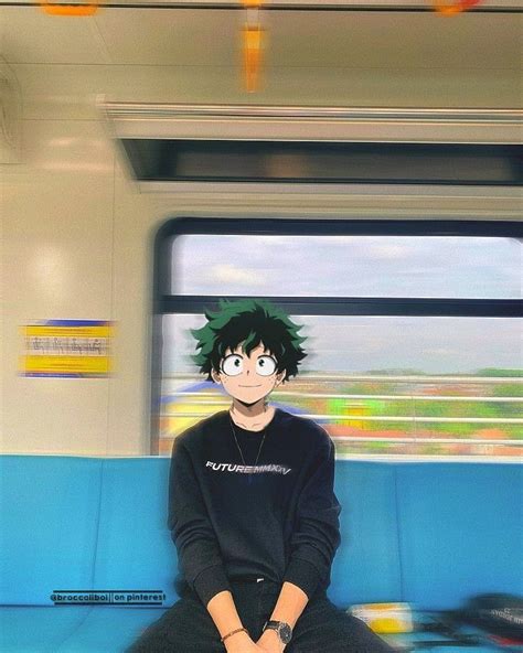 a man with green hair sitting on a train