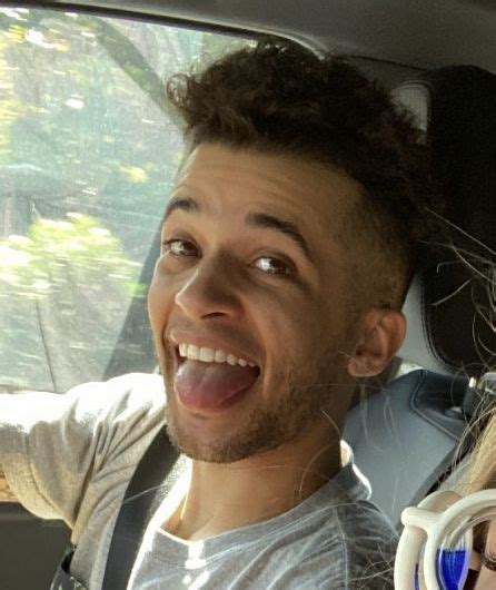 A Man And Woman Sitting In The Back Seat Of A Car With Their Mouths Open