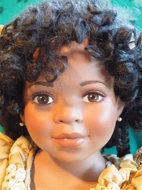 A Close Up Of A Doll With Curly Hair