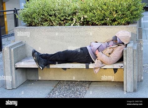 A Homeless Man Sleeping On The Bench In Downtown Vancouver British