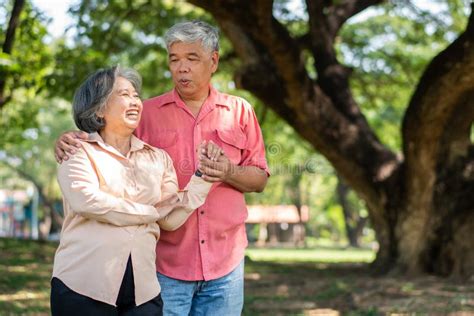 Portrait Of Lovely Elderly Couple Hugging Each Other With Love And