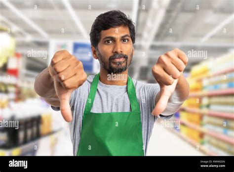 Indian supermarket or hypermarket employee man making double thumbs ...