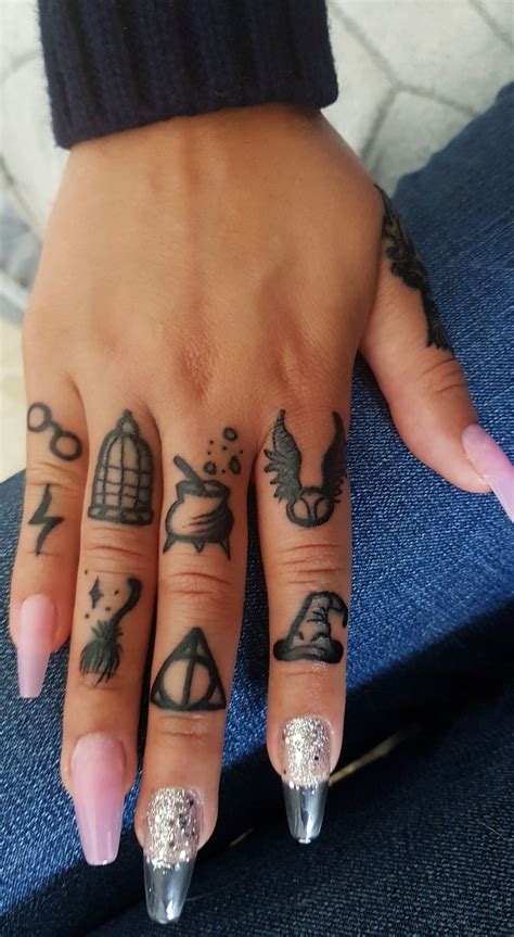 A Woman S Hand With Tattoos On It