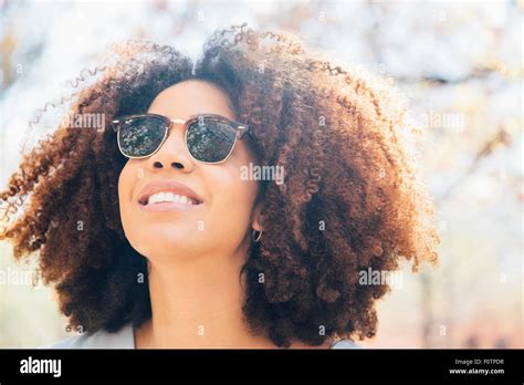 Close Up Portrait Of Mid Adult Woman Wearing Sunglasses Smiling