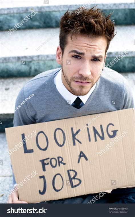 Young Businessman Holding Sign Looking For A Job Stock Photo 48556024