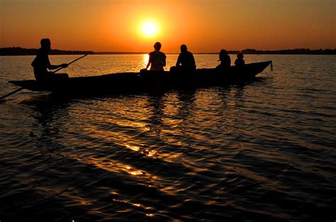 Boat in sunset on Chilika Lake India Photograph by Diane Lent - Pixels