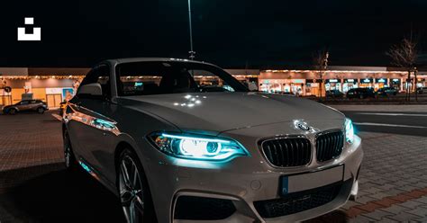 White Bmw M 3 Parked On Parking Lot During Night Time Photo Free