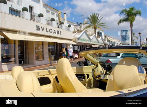 Luxury Car And Shops At The Exclusive Yacht Harbour Of Puerto Ban S