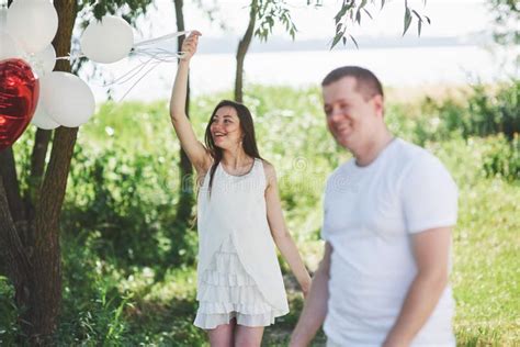 Happy And Young Pregnant Couple Hugging In Nature Romantic Moments