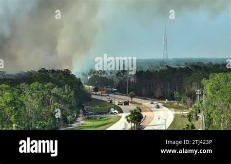 Fire Department Firetrucks Extinguishing Wildfire Burning Severely In