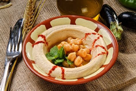 Premium Photo | Plate of arabic traditional hummus with peas grains.