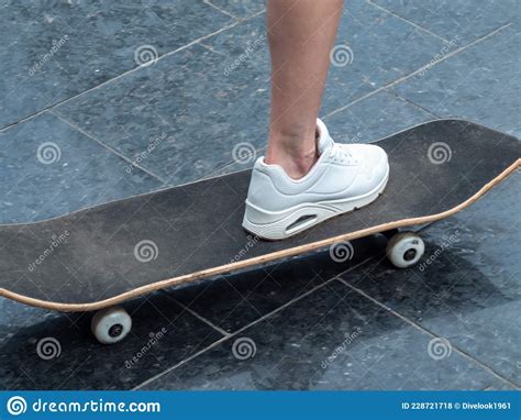 The Girl Rides A Skateboard Legs And Skateboard Close Up Stock Photo