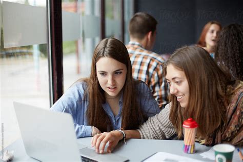 Two Female Students Working With A Computer In The University