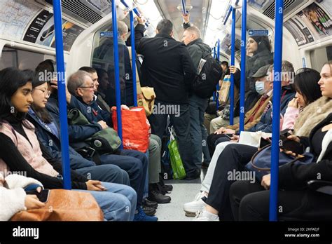 Crowded London Underground Train Passengers Standing In The Tube