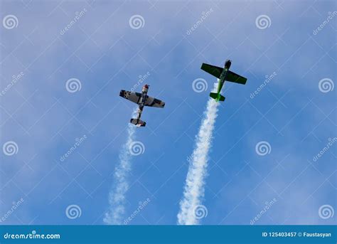 Two Yak-52 Aircraft in the Sky Perform Aerobatics Figures. Editorial ...