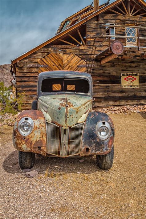 1940 S Rusty Ford Automobile In Front Of An Old Wooden Garage Nevada