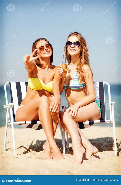Girls In Bikinis With Ice Cream On The Beach Stock Photo