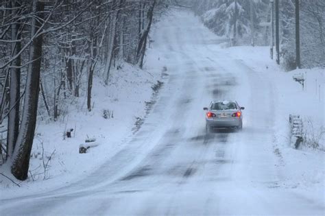Winter storms dump snow on both US coasts as icy roads make for