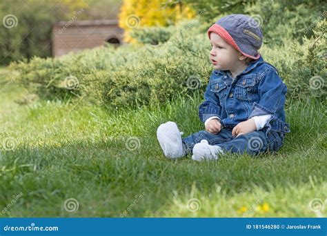 Aggressive Angry Baby Boy Is Sitting On The Grass Stock Photo Image