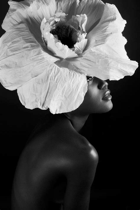 A Woman With A Large White Flower On Her Head