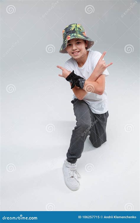 A Little Boy, Standing on One Knee, Making a Rock`n`roll Gesture with His Hands. Stock Image ...