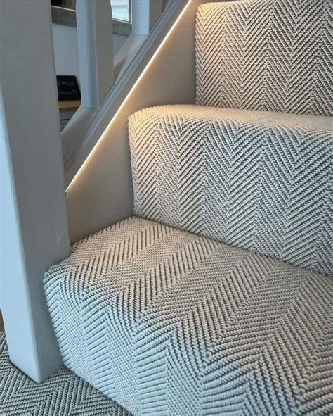 The Stairs Are Lined With Herringbone Carpet And Illuminated By Led