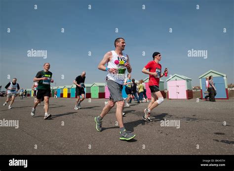 Runners Pass Brightly Painted Beach Huts At Hove During The Last Few