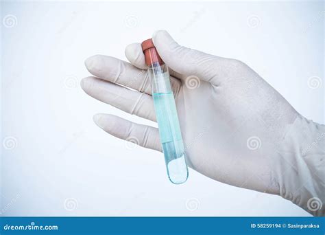 Glass Jar With A Tube With Freshly Squeezed Orange Juice Stands On A White Background Next To