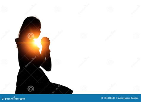 Silhouette Of Woman Praying Over Beautiful Sky Background Stock Photo