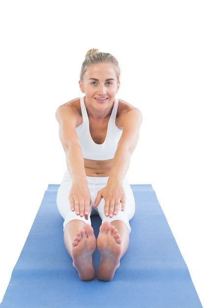 Premium Photo Toned Smiling Blonde Sitting On Exercise Mat Stretching