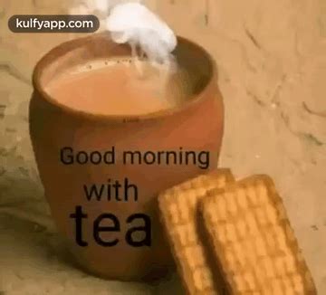 A Cup Of Tea And Some Cookies On A Table With The Caption Good Morning