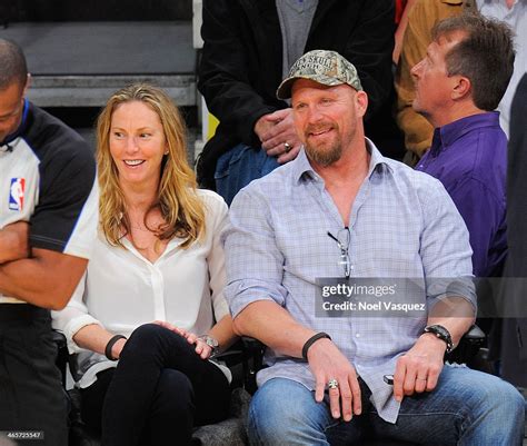 Stone Cold Steve Austin and Kristin Feres attend a basketball game ...