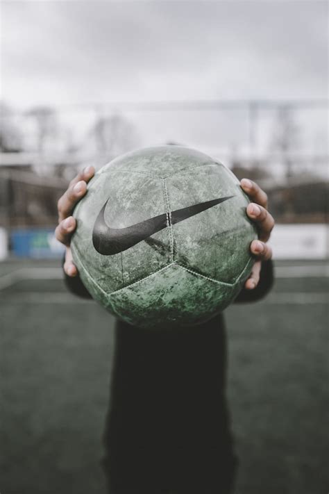 HD wallpaper: green and black Nike soccer ball beside person standing ...