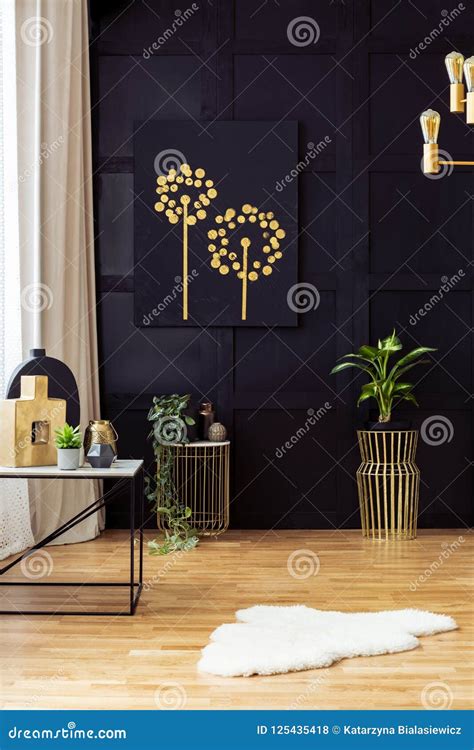 Elegant Living Room Interior With Golden Accents Painting On A Black