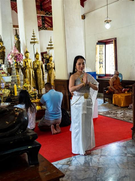 Praying Lady In Traditional Thai Clothes With Buddhist Monk And