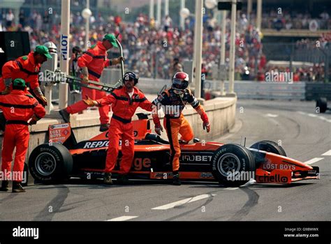 Jos Verstappen climbs out from his wrecked Arrows after crashing out of ...