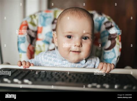 Portrait Of A Cute Little Caucasian Baby Boy Sitting And Playing With A