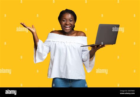 Happy Black Woman Holding Laptop And Exclaiming With Excitement Stock