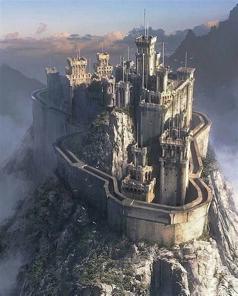 a castle on top of a mountain surrounded by fog