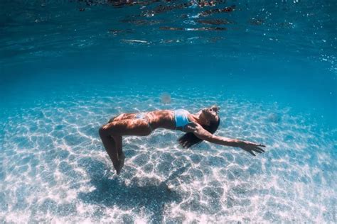 Naked Woman Free Diver Glides Over Sandy Sea With Fins Freedivi