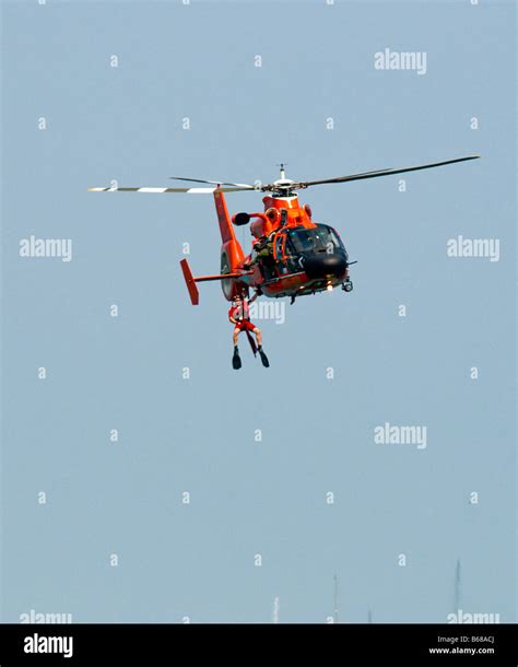 U.S. Coast Guard Helicopter & Boat Rescue / Lifting rescue swimmer out of water Stock Photo - Alamy