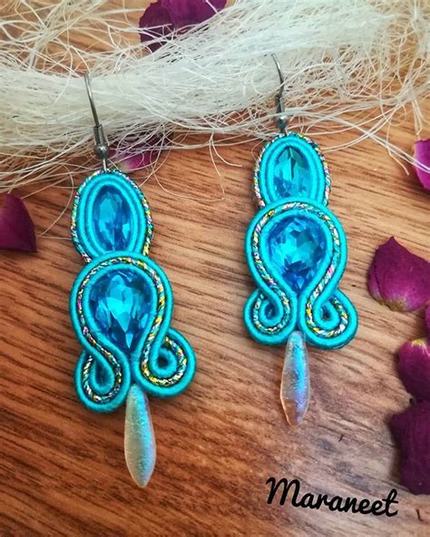 The Earrings Are Made With Blue Glass Beads And Beadwork On Top Of Wood