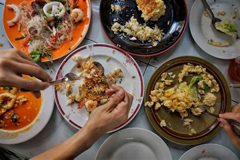 Premium Photo Cropped Hands Of People Eating Food On Table