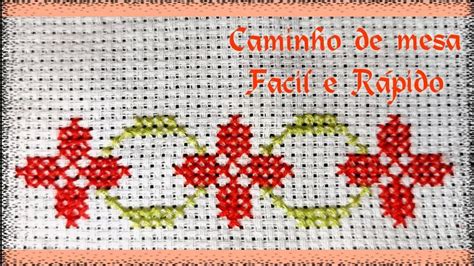 A Cross Stitch Pattern With Red And Green Flowers On White Fabric The