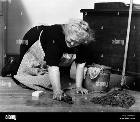 1930s Senior Woman Character Charwoman Cleaning Scrubbing Floors On