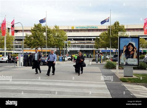 Exterior of Terminal 2 Melbourne International Airport Australia with pedestrians walking ...