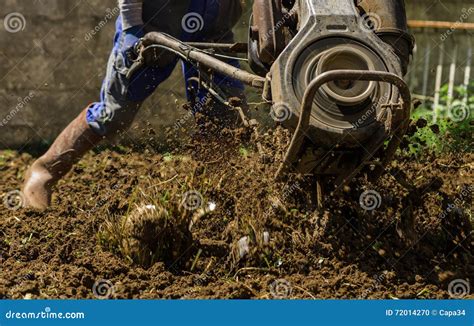 Farmer Using Machine Mart Cultivator for Ploughing Soil Stock Photo ...