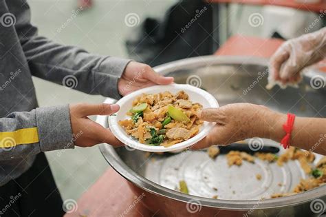 Hands Of Volunteers Serves Free Food To The Poor And Needy In The City